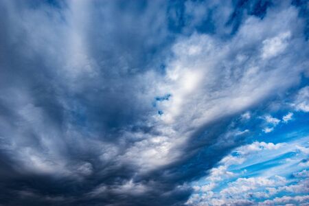 Dark storm clouds before rain at sunset.