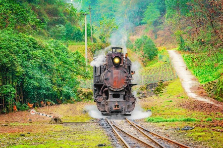 Steam narrow-gauge locomotive stands at the station on the way from Yuejin to Bagou. Jiayang Mining Region. Sichuan province. Chinaの写真素材