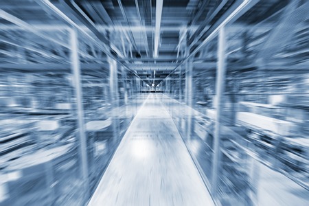Blurred image of the transparent corridor inside of the modern plant.