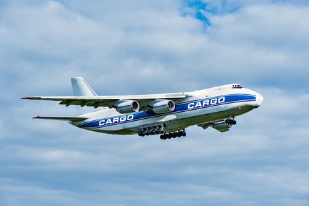 Flight of the big cargo airliner at sunny day time.の写真素材