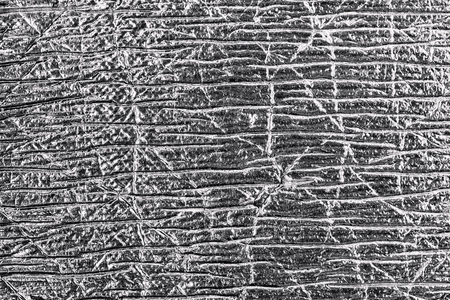 Close up of the gray foil abstract textured background.の写真素材