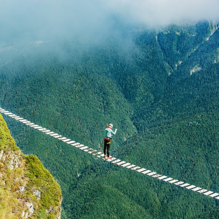 Woman crossing the abyss.の写真素材
