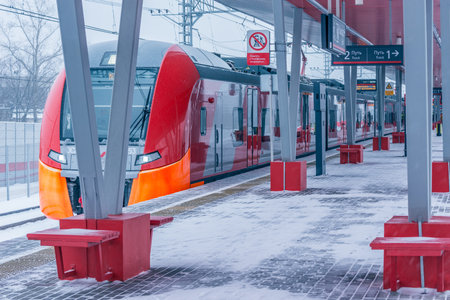 Moscow, Russia - January 20, 2018: Highspeed train stands by the Rostokino station platform at snowstormy day time.のeditorial素材