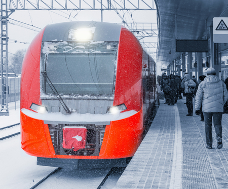 Highspeed train stands at the station platform at winter evening time.の写真素材