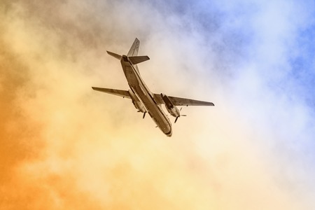 Freight military plane in the cloudy sky.