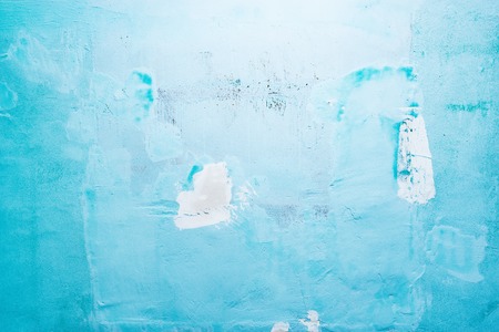 Plaster on the blue wall texture background.