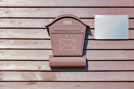 Mail box on the wooden fence by private house.の写真素材