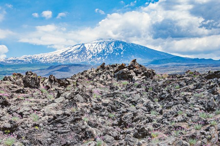 Hills of lava on Etna volcano background. Sicily.