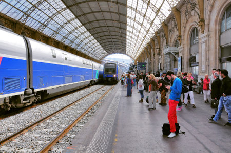 Nice, France - May 23, 2012: Passengers wait for the local train arrival.
