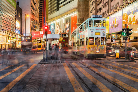 Central District, Hong Kong - December 11, 2016: Retro tramways, bus and people on the city streets.のeditorial素材