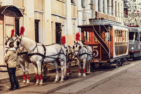Moscow, Russia - April 17, 2019: Horses and passenger vintage carriage on the town street in the historical city center before the repetition of traditional trams parade.のeditorial素材