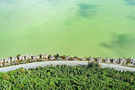 Aerial view of the road and rich houses by Dianchi lake. Kunming. China. View from West mountains.の写真素材