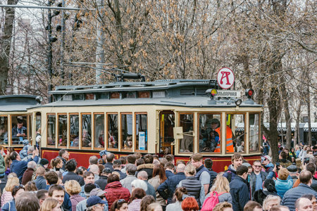 Moscow, Russia - April 21, 2019: Vintage trams and crowd of people on the town street at retro trams parade time.のeditorial素材