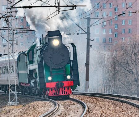 Retro train departs from railway station building. Moscow.