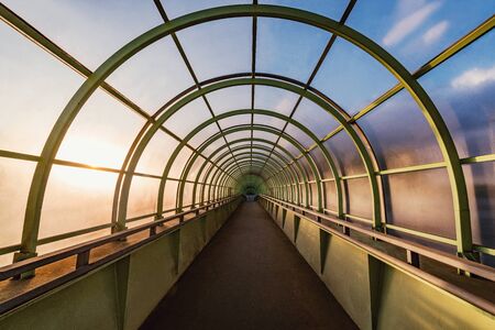 Metal and glass corridor above the highway.の写真素材