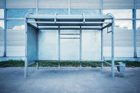 Empty metal bus stop by the highway.の写真素材
