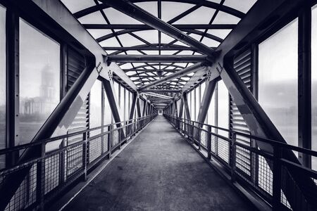 Metal and glass corridor above the highway.