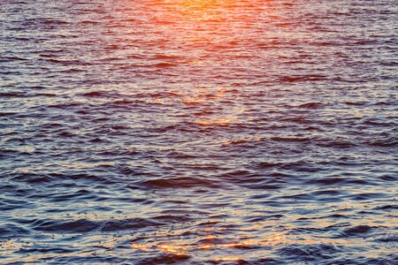 Sunset view of the sea surface at summer time.