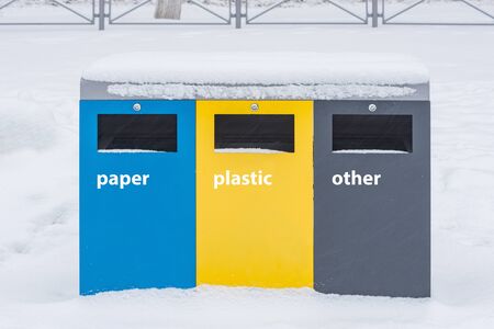 Multicolored bin for separate waste collection in winter park.の写真素材