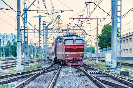Moscow, Russia - June 09, 2019: Passenger retro electric czech locomotive CHS-2T with train departs from the station at sunset time. CHS-2T was made by Skoda and started to use since 1974 year.のeditorial素材
