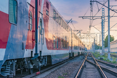 Moscow, Russia - June 03, 2019: Passenger train departs from the station at sunset time.のeditorial素材