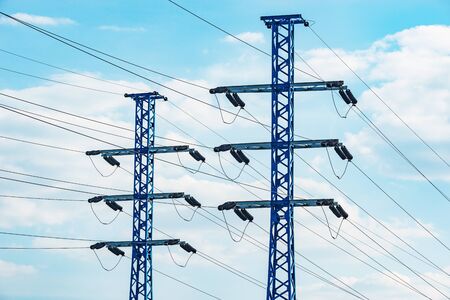High-voltage towers on the day sky background.
