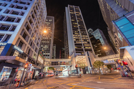 Central District, Hong Kong - December 13, 2016: Retro tramways and people on the city streets at...