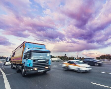Cars move on the highway at sunset time.の写真素材
