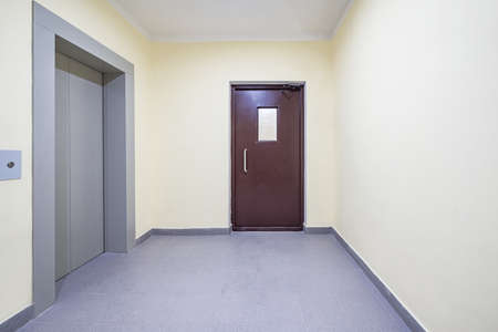 ?losed elevator doors inside of the apartment building.