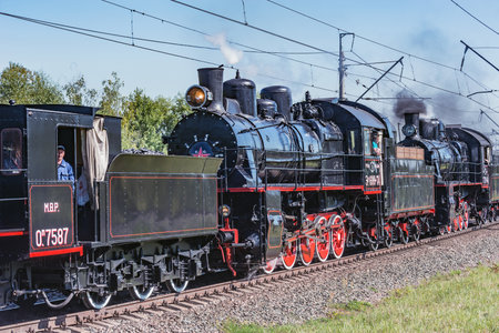 Moscow, Russia - August 30, 2019: Steam locomotives moves along the forest.のeditorial素材