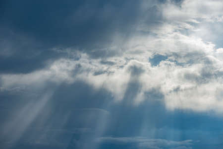 Sun rays break through the stormy clouds.の写真素材