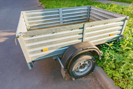 Small trailer stands on the city street.の写真素材