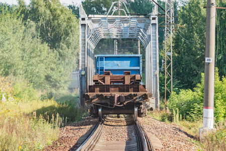 Freight train moves through the bridge at summer day time.の写真素材