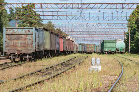 Freight trains stand on the station at evening time.の写真素材