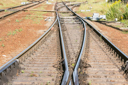 Railway tracks on the station at evening time.の写真素材