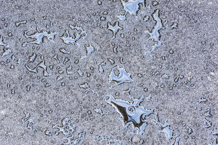 Water on the new asphalt road surface.の写真素材