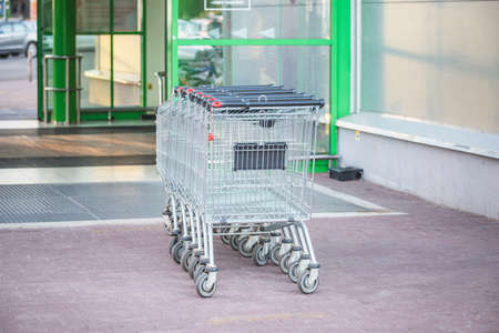 Shopping carts by the entrance of the supermarket.の写真素材