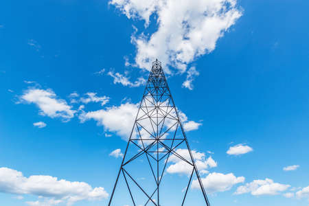 Old metal tower on blue sky background.の写真素材