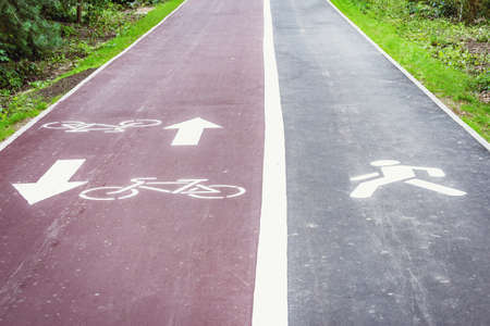 Bicycle and people signs on the asphalt city road.の写真素材