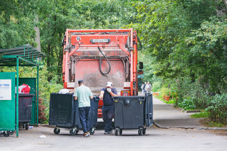 Korolev, Russia - September 02, 2020: Process of garbage loading to the garbage truck.のeditorial素材