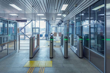 Turnstiles with electronic card readers on the station platform.の写真素材