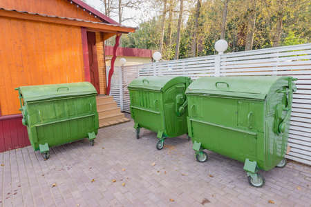 Metal containers for the waste collection by the supermarket bullding.