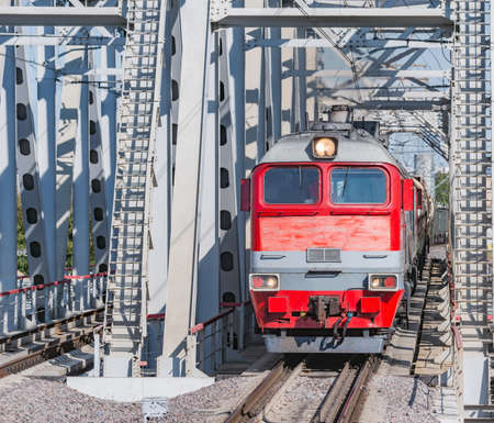 Diesel freight train moves through the bridge.の写真素材