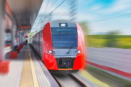 Highspeed train moves fast along the passenger platform.の写真素材