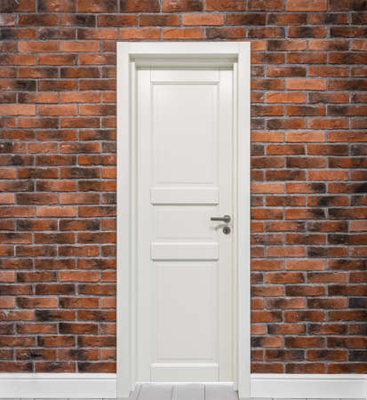 White door in the red brick wall.の写真素材