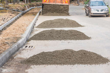 Tipper makes the road on the construction site.の写真素材