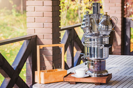 Samovar on the wooden table. Samovar - epuipment for tea preparation.の写真素材