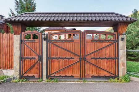 Wooden new gate by the house at summer time.の写真素材