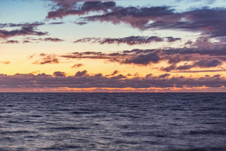 Sunset sky over the surface of the sea.の写真素材