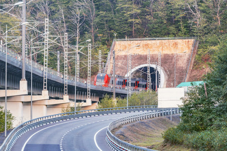 Passenger train moves from the tunnel. Caucasus. Russia.の写真素材